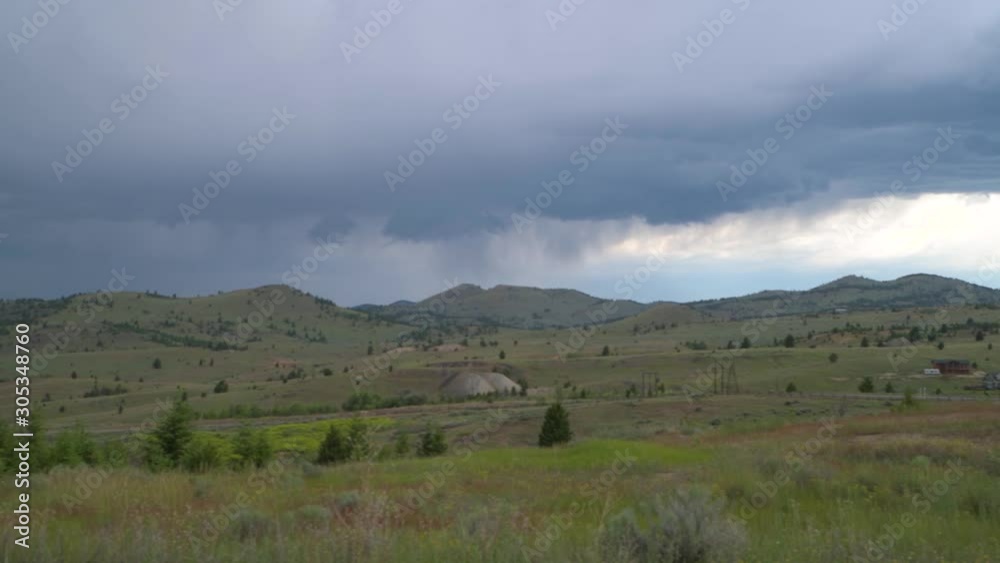 Country side pan on a cloudy evening with a thunderstorm in background. Country side pan on a cloudy evening with a thunderstorm in background.