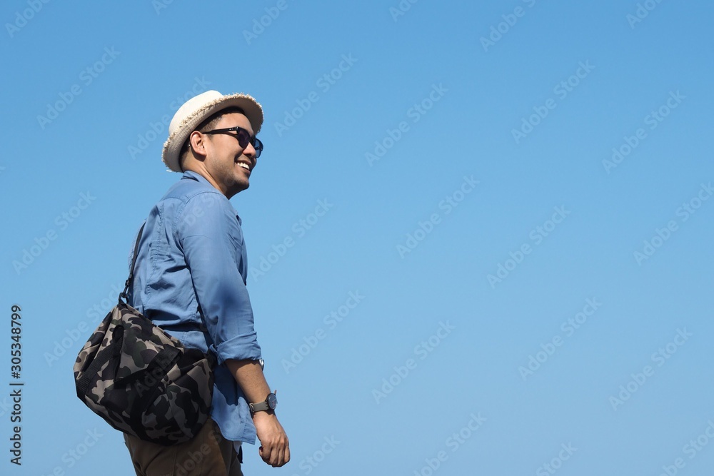 young man on background of blue sky young man on background of blue sky