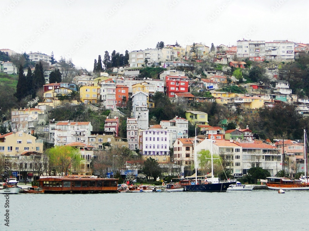 Panorama view of Istanbul of Bosporus and Golden Horn bank. Tourism yachts on Bosphorus with Istanbul cityscape in the background.