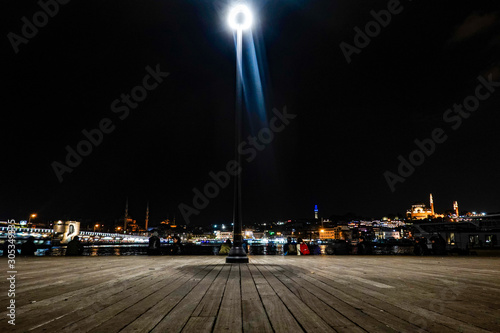 Istanbul, Turkey A boardwalk near the Galata Bridge illuminated by a street lamp. © Alexander
