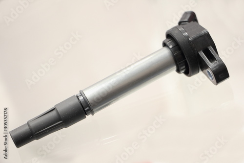 New car engine individual ignition coil on white background close up