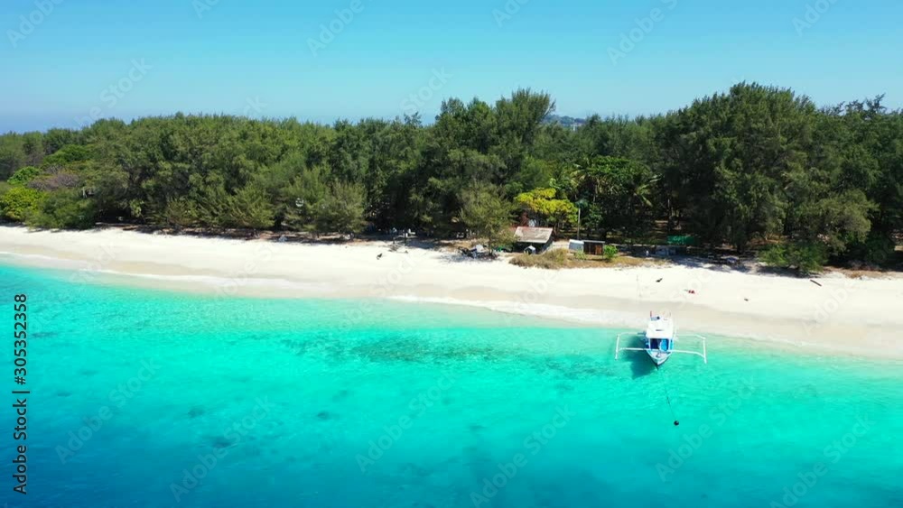 A Beach In The Philippines - Tropical Paradise Of Green Trees, White Sand, And Clear Blue Sea Waters With A Boat Docked On The Shore On A Sunny Day - Aerial Drone Shot A Beach In The Philippines - Tropical Paradise Of Green Trees, White Sand, And Clear Blue Sea Waters With A Boat Docked On The Shore On A Sunny Day - Aerial Drone Shot