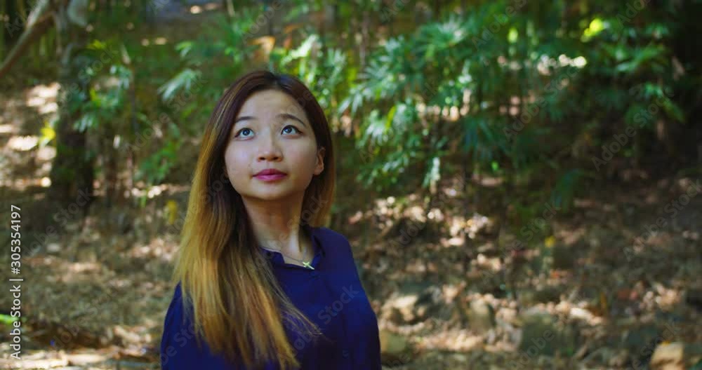 Young Attractive Asian Woman Walks Amongst Tropical Flora, SLOW MOTION Young Attractive Asian Woman Walks Amongst Tropical Flora, SLOW MOTION