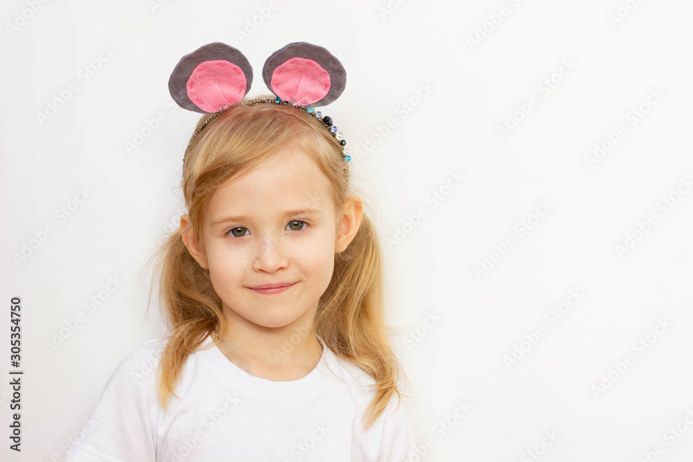 child girl on a white background, in a white T-shirt with mouse ears on her head, smiling, portrait, place for an inscription child girl on a white background, in a white T-shirt with mouse ears on her head, smiling, portrait, place for an inscription