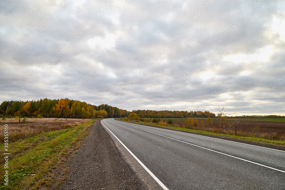 Track from the car window and white clouds on blue sky. Natural landscape Track from the car window and white clouds on blue sky. Natural landscape