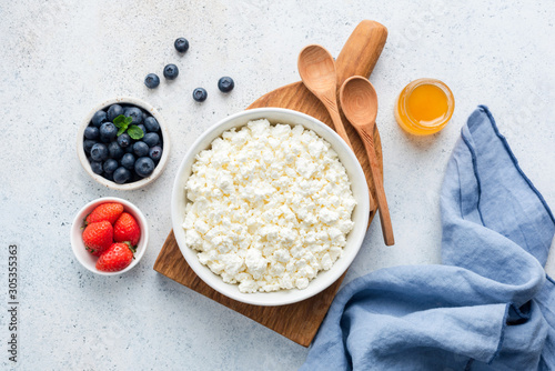 Cottage Cheese In Bowl. Homemade Curd Cheese Served With Fresh Berries Blueberry Strawberry And Honey. Fermented dairy product rich in Protein, healthy fats and Caclium