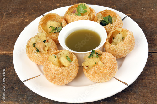 Tadeonal subcontinental street snack food chickpeas potato pani puri fuska with tamarind sauce