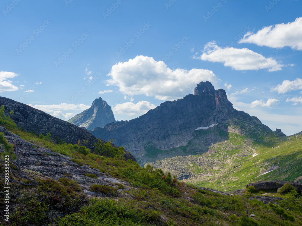 View of the mountain peaks in the Ergaki Nature Park. Sunny summer day in the mountains of the Western Sayan View of the mountain peaks in the Ergaki Nature Park. Sunny summer day in the mountains of the Western Sayan