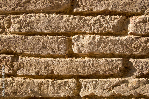 Wall texture of old adobe bricks. Close up photo