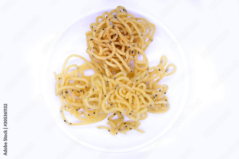 South Indian Homemade Murukku isolated on white with copy space / Diwali snacks South Indian Homemade Murukku isolated on white with copy space / Diwali snacks