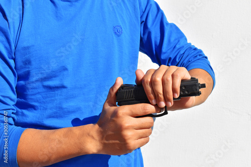 Man in a jeans holding a gun Robbery attack concept.