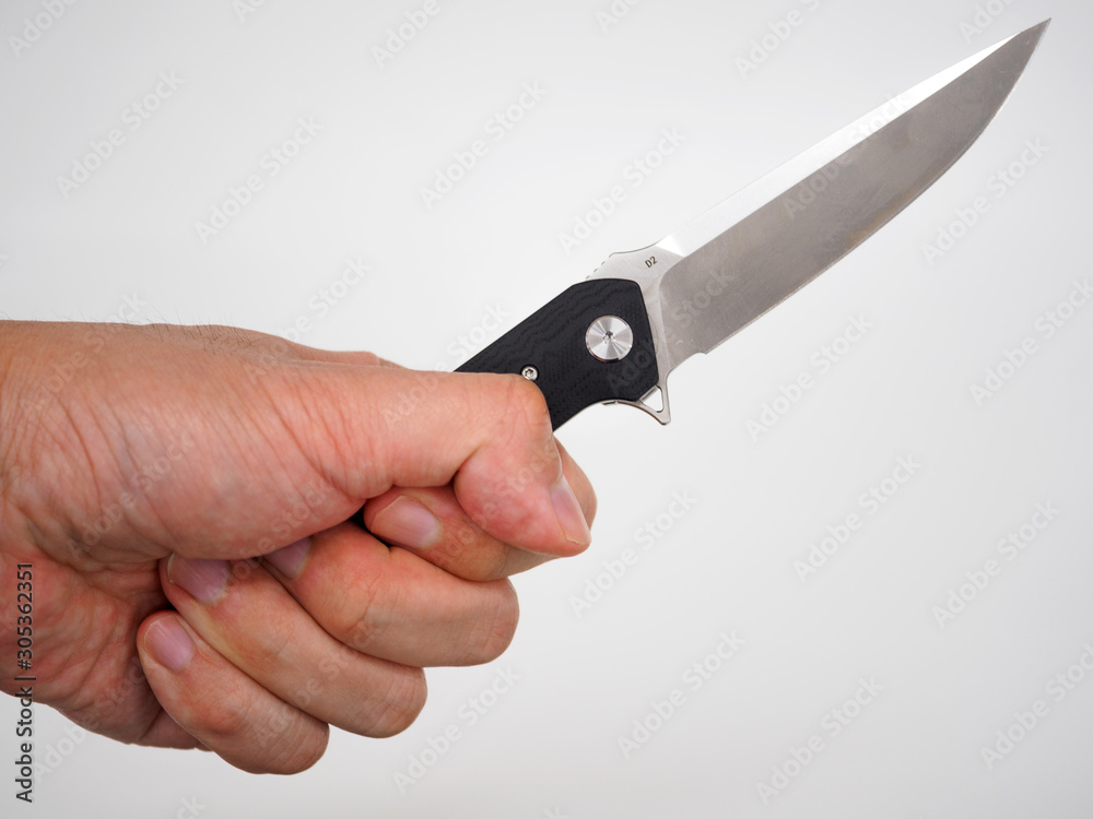 Hand holding a pocket-knife isolated on white background Hand holding a pocket-knife isolated on white background