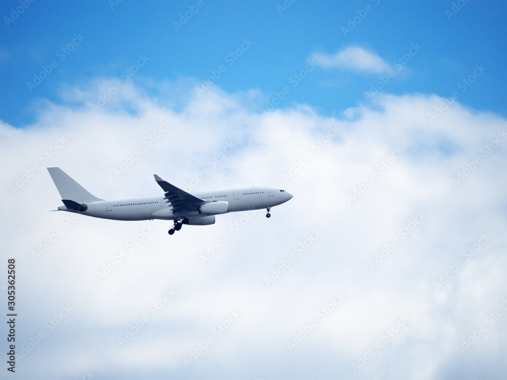 Passenger plane flies in the sky on the background of clouds Passenger plane flies in the sky on the background of clouds