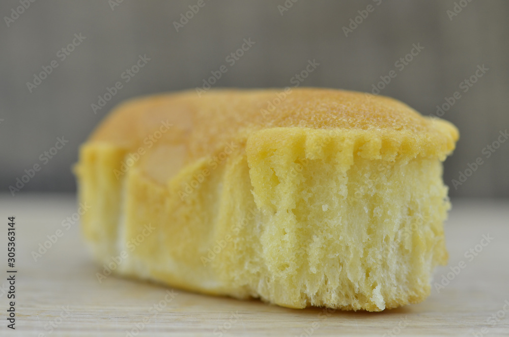 Delicious soft bread on a wooden background. One Delicious soft bread on a wooden background. One