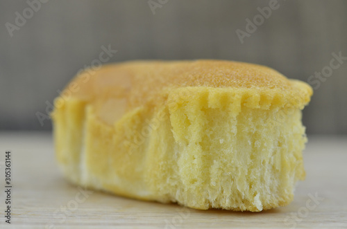 Delicious soft bread on a wooden background. One