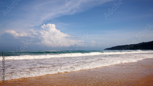 Waves, surf, and the blue sky over the sea, Karon sandy beach on a sunny day, Thailand © VP