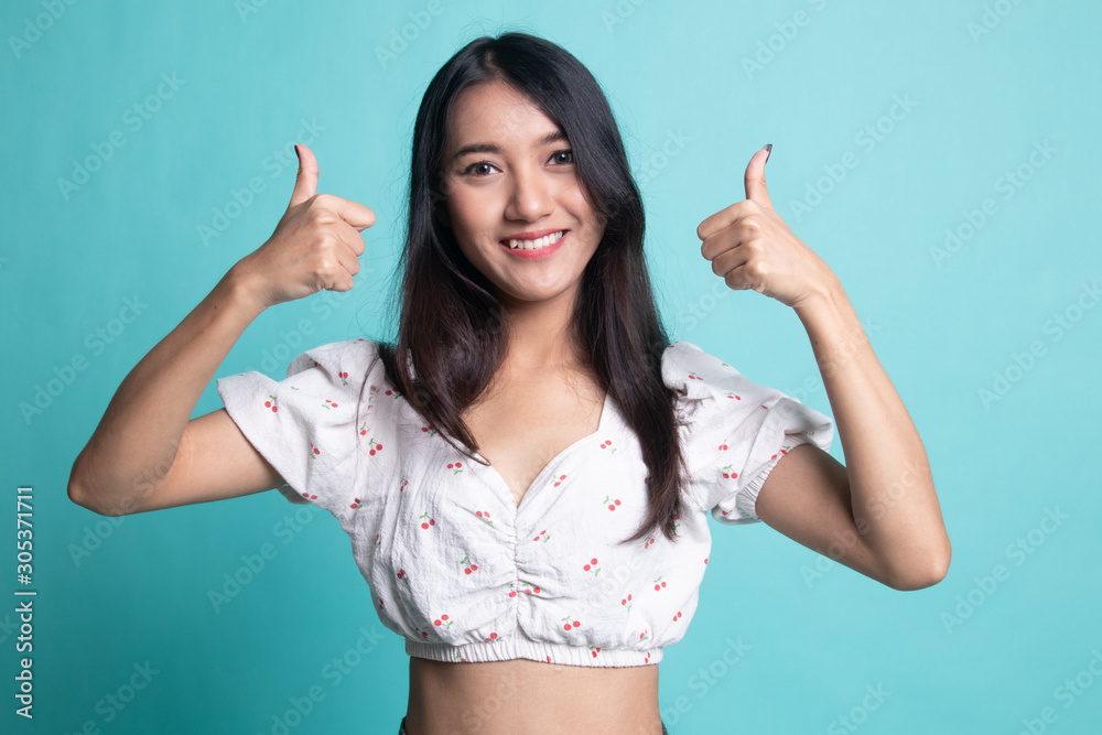 Young Asian woman show two thumbs up. Young Asian woman show two thumbs up.