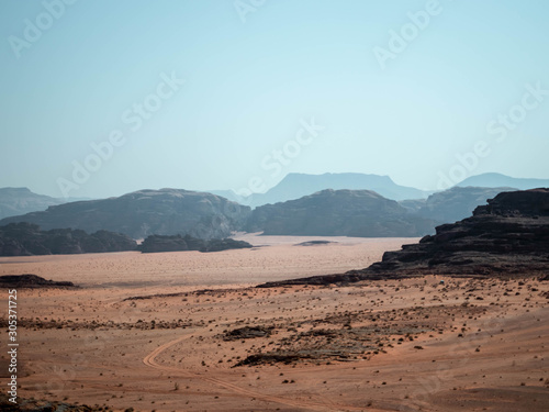 Mountains in the distance of the desert of Wadi Rum from a rocky outcrop