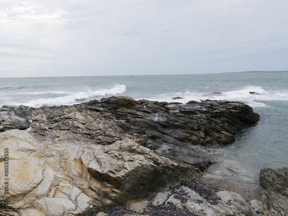Limestone rocks extending into the water of a coastal area Limestone rocks extending into the water of a coastal area