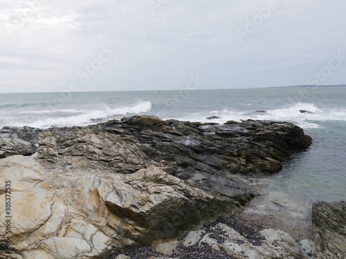 Limestone rocks extending into the water of a coastal area