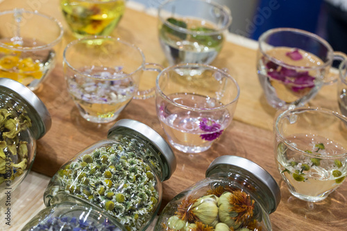 different healing herbs in glass bottles, flowers tea