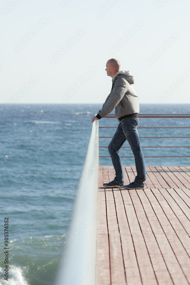A young man standing on the sea shore A young man standing on the sea shore
