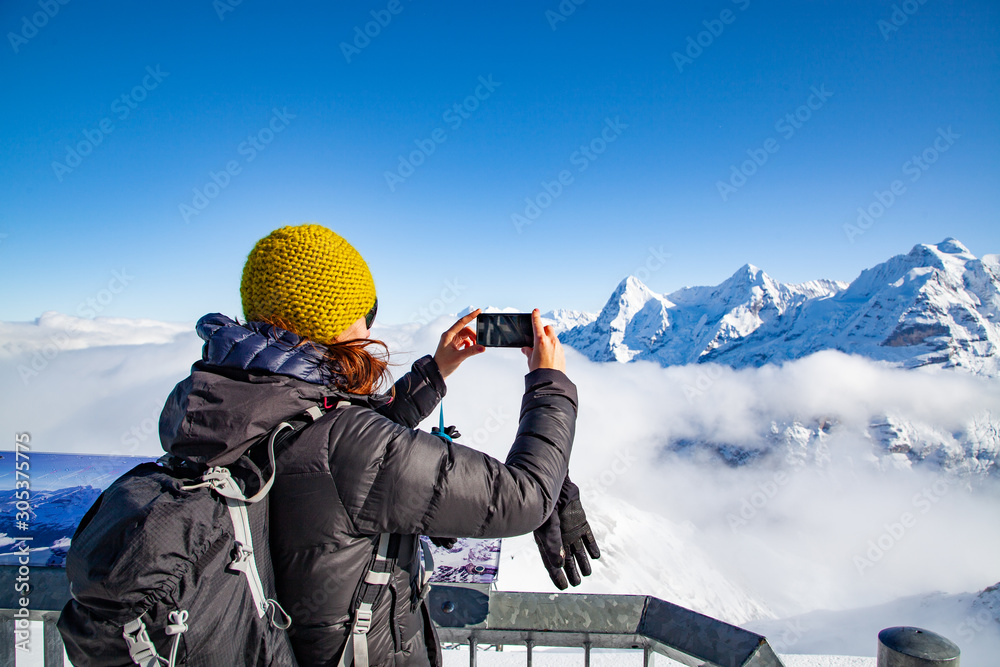 woman traveler in Swiss alps Jungfrau region taking pictures