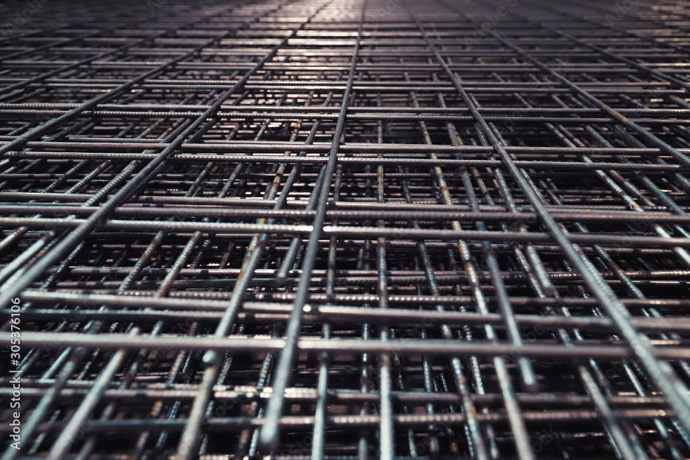 Fototapeta premium Steel bar for building materials. Wire reinforcing mesh. Industrial grunge background.