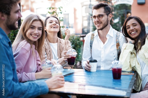 Group Of Friends Drinking Cocktails At Outdoor Bar