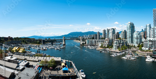 Panoramic view of granville island and  Burrard Street Bridge in Vancouver downtown, Cityscape with blue sky, BC, Canada © Fangzhou