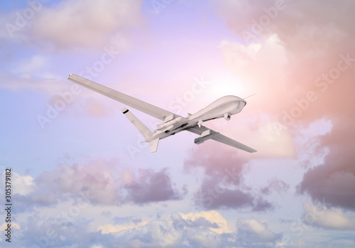 Spy unmanned aerial vehicle (UAV) flies over white clouds in blue sky natural background on sunset