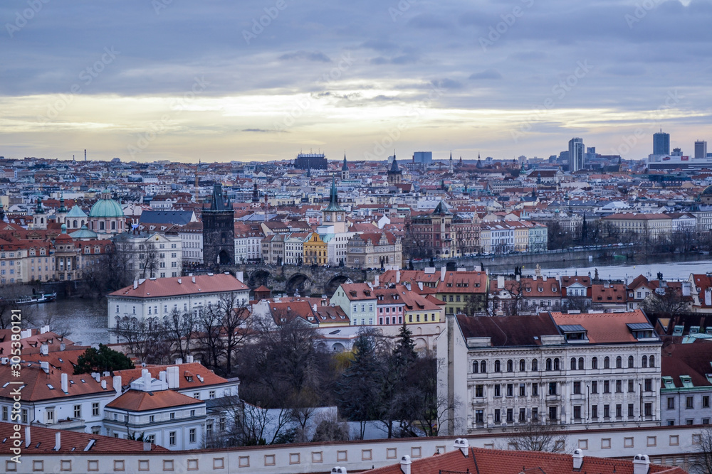 Aerial view of cityscape of old town of Prague, with a lot of rooftops, churches, and the landmarks.
