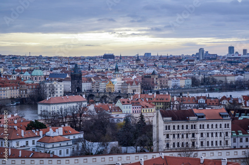 Aerial view of cityscape of old town of Prague, with a lot of rooftops, churches, and the landmarks.