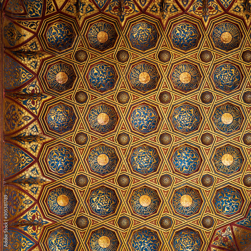 Golden floral pattern decorations, part of ceiling of Mausoleum of Sultan Qalawun, Sultan Qalawun Complex, located in Muizz Street, Gamalia district, Cairo, Egypt photo