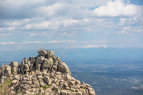 View from the top of the Caramulo mountains over the Estrela mountains, granitic rocks and undergrowth photo