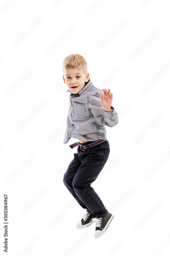 Jumping boy of preschool age. Sport and activity. Isolated over white background. Vertical. Jumping boy of preschool age. Sport and activity. Isolated over white background. Vertical.