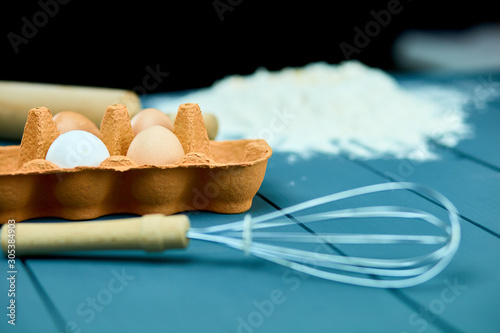 Baking ingredients background, baking concept, top view. Copy space. Falt lay. Raw dough for cookies. Kitchen utensils and ingredients for cooking baking photo