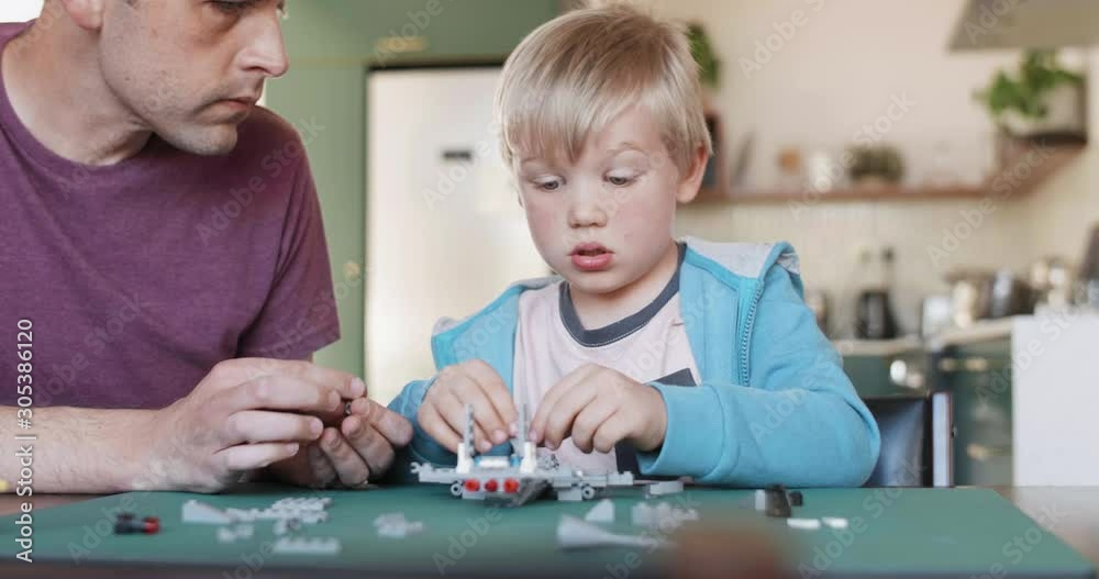 Young boy building model aeroplane from blocks, puzzle game mental stimulation father son activity Young boy building model aeroplane from blocks, puzzle game mental stimulation father son activity
