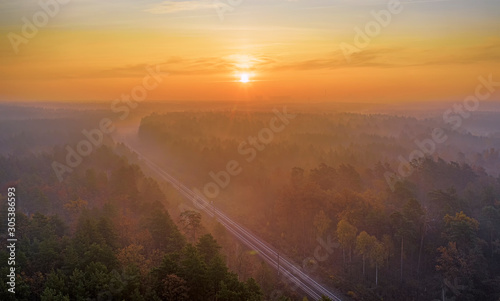 Railway in autumn blurred forest at dawn