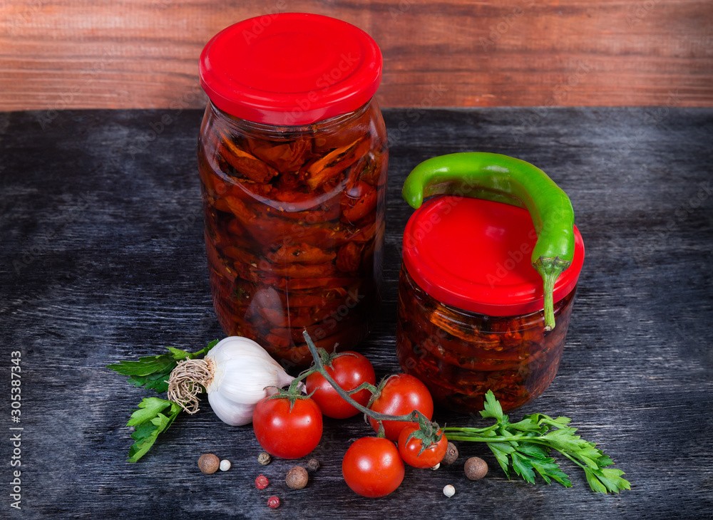 Sundried tomatoes in olive oil in glass jars among ingredients Sundried tomatoes in olive oil in glass jars among ingredients