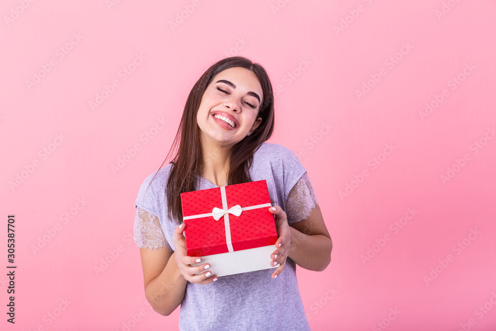 Portrait of young lovely nice sweet glamorous girl lady, wearing gray top, carrying gift box, wondering about surprise. Isolated over bright vivid yellow background Portrait of young lovely nice sweet glamorous girl lady, wearing gray top, carrying gift box, wondering about surprise. Isolated over bright vivid yellow background