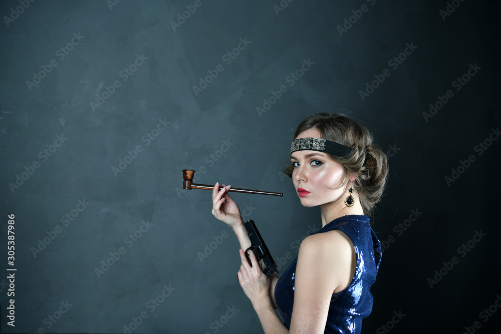 girl in evening blue dress with a pipe