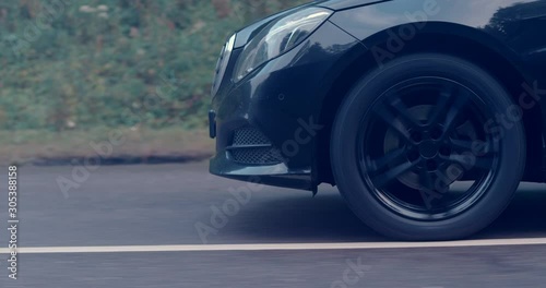 Reflecting everything around with its glossy surface, the premium car rides asphalt road where you can observe the suspension and how the tires perceive driving conditions