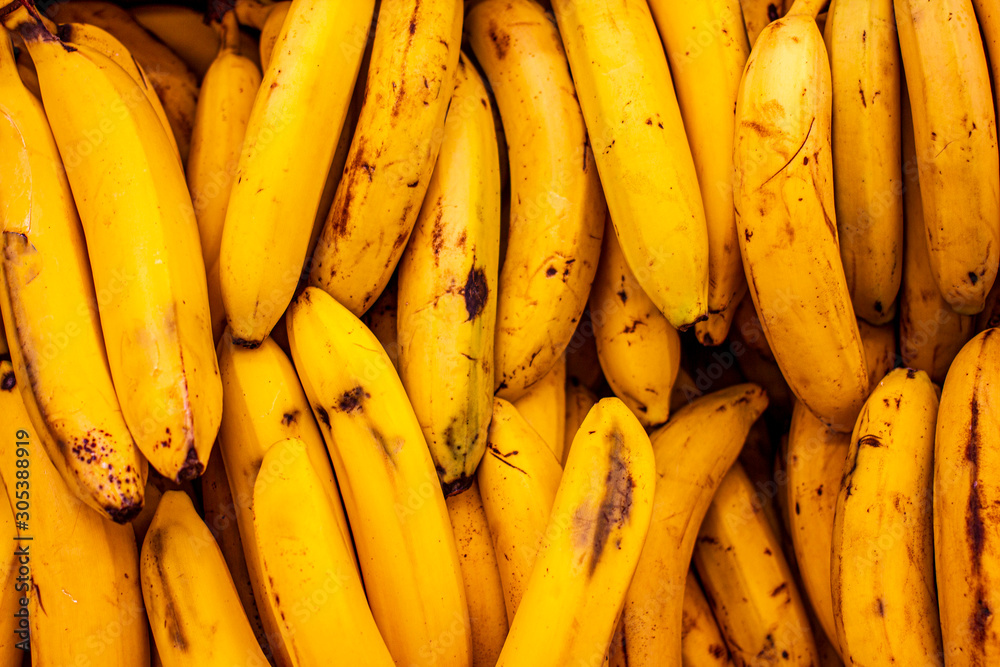 Banana close-up background. Ripe yellow bananas closeup, pattern. Fruit background, veggie concept, fruit menu, healthy lifestyle