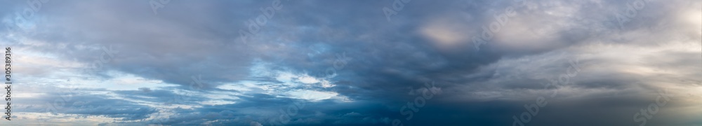 Fantastic clouds against blue sky, panorama