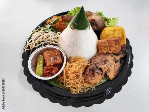 Nasi Tumpeng. Yellow rice in a cone shape. A festive Indonesian rice dish with side dishes photo