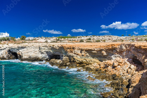 Rocky shore, clear turquoise sea water and blue sky in Ayia-Napa, Cyprus, sculpture park.