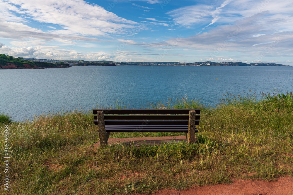 A bench at the coastline between Broadsands and Elberry Cove, Torbay, England A bench at the coastline between Broadsands and Elberry Cove, Torbay, England