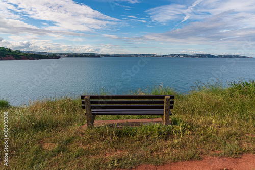 A bench at the coastline between Broadsands and Elberry Cove, Torbay, England