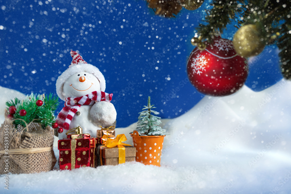 Snowman in a snowdrift with gifts for Christmas and New year Snowman in a snowdrift with gifts for Christmas and New year